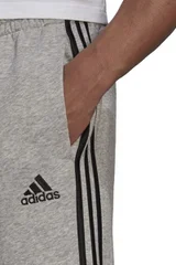 Sportovní tepláky ADIDAS Essentials s úzkým lemem a třemi pruhy