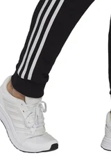 Pánské černé sportovní kalhoty Essentials Tapered Cuff 3 Stripes  Adidas